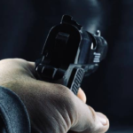 Personas haciendo tiro al blanco en balneario Tranqueras con un revólver