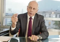 El Dr. Gustavo Salle gesticulando con énfasis durante una entrevista sobre el recorte de legisladores en Uruguay.