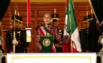 La presidenta Claudia Sheinbaum saludando desde el balcón presidencial durante los festejos patrios.