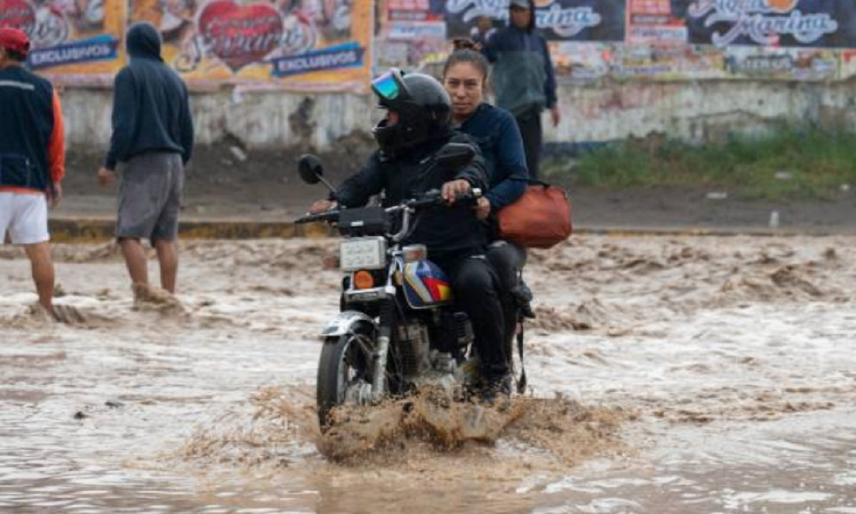 Crecida del caudal del río Tumbes amenazando los márgenes urbanos en Perú.
